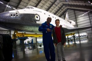 Ryan Bean of Scotts Valley, California winner of the Space Container Challenge with Astronaut Leland Melvin during tour of the Space Shuttle Endeavour at the California Science Center.