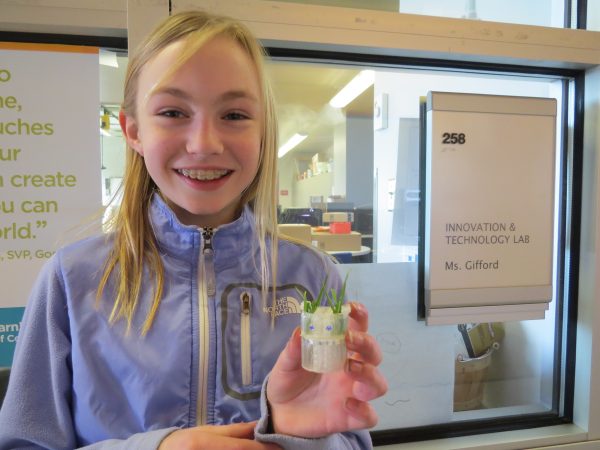 Sydney Vernon of Bellevue, Washington holds the space planter she designed as part of the Space Tools Challenge.
